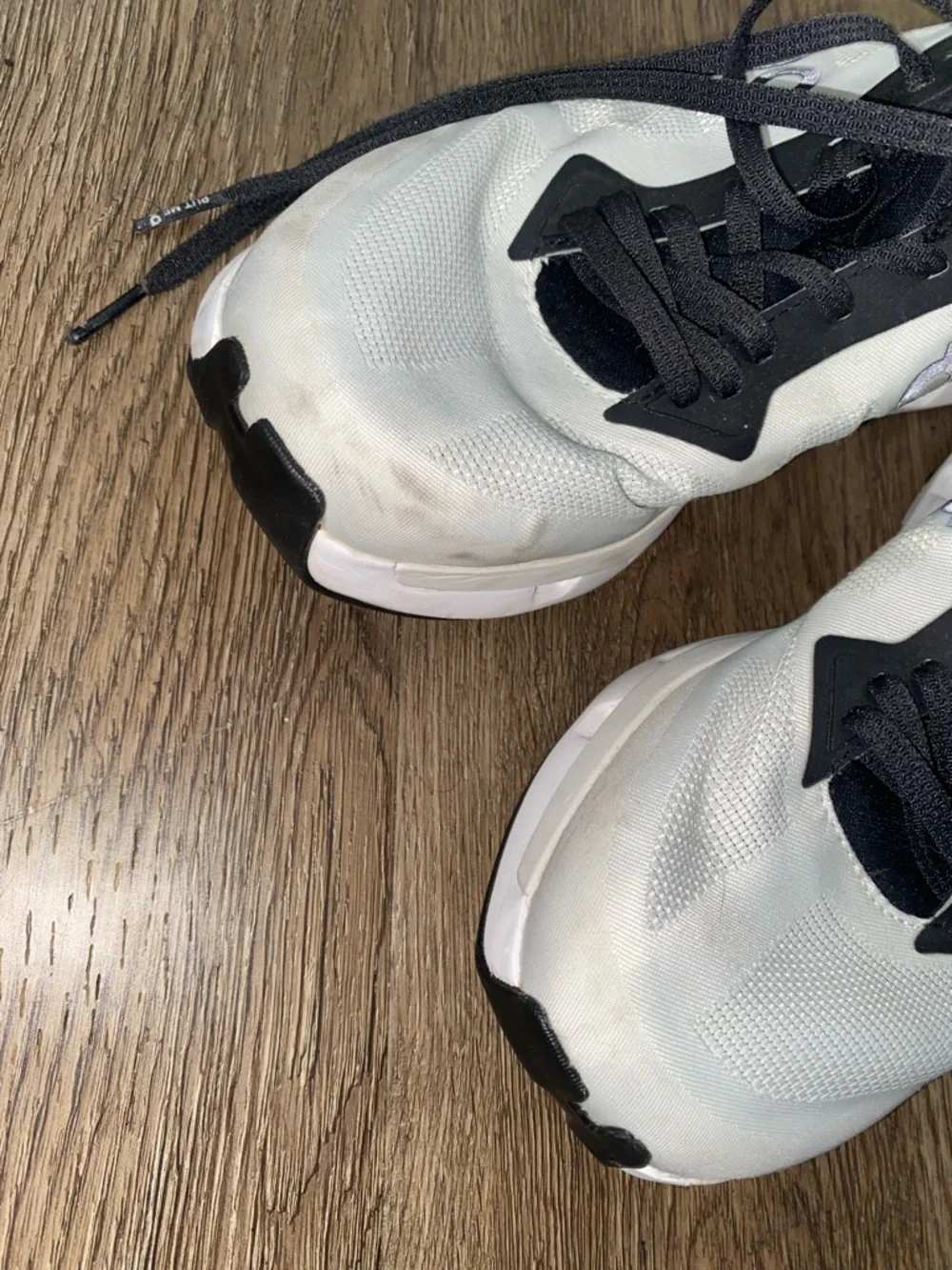 On Running Men’s White and Black Athletic Running Shoes